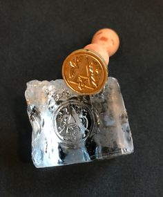 a penny sitting on top of an ice block