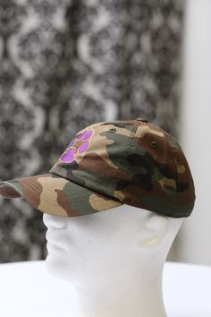 With unique designs you won't find anywhere else, our caps are the quality type that are designed with a thicker woven fabric. Not those flimsy weak ones that lose shape. 100% stitched embroidered design. Sport cap. Curved brim. Dry Clean Only Comes in: adjust back. Perfect for those debonair que dawgs who needs head/face protection from the sun, sweat and elements while out doing fitness, events or anything fun. Outdoor Camouflage Cotton Baseball Cap, Brown Cotton Fitted Cap, Brown Cotton Dad Hat, Trendy Dad Hat With Curved Visor For Outdoor, Trendy Dad Hat With Curved Bill For Outdoor, Trendy Outdoor Dad Hat With Curved Visor, Trendy Brown Dad Hat With Curved Bill, Brown Baseball Cap For Streetwear, Brown Cotton Baseball Cap