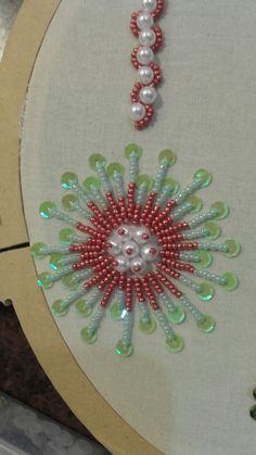 the bead work is being displayed on the table