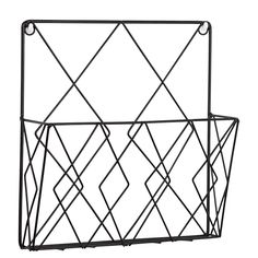 a black metal basket with geometric designs on the front and sides, hanging from a white wall