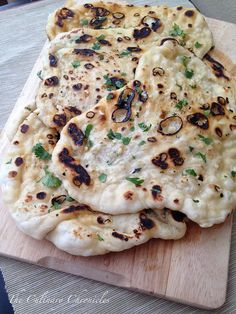 several flat breads on a cutting board ready to be cooked and served for consumption