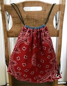 a red and white bag sitting on top of a wooden chair