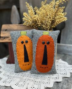 two decorative pumpkins are sitting on a table