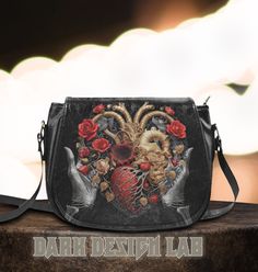 Introducing our enchanting Top Handle/Cross Body Vegan Leather Handbag, a captivating fusion of mystical witchy, gothic allure, and the whimsical charm of cottagecore aesthetics. Crafted with meticulous attention to detail, this exquisite handbag seamlessly weaves together elements of mystery and romance, making it a truly captivating accessory for the modern soul. Immerse yourself in the ethereal world of magic and style with this spellbinding creation. This handbag boasts an ideal size to carry your essentials while making a powerful fashion statement. Designed to resonate with your unique sense of style, it flawlessly marries the dark elegance of gothic motifs with the nostalgic, pastoral beauty of cottagecore accents. Crafted from premium vegan leather, this handbag not only exudes opu Gothic Satchel Gift Bags, Gothic Satchel Bag As Gift, Gothic Satchel Bag For Gift, Gothic Satchel Shoulder Bag Gift, Gothic Style Satchel Shoulder Bag For Gift, Gothic Bags For Halloween Gift, Gothic Halloween Gift Bags, Gothic Crossbody Shoulder Bag As Gift, Gothic Crossbody Shoulder Bag For Gift