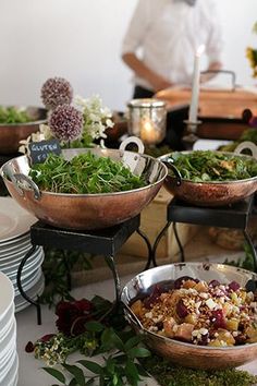 a table filled with lots of different types of food and plates on top of it