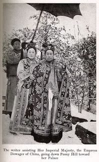 an old black and white photo of two women in traditional chinese garb holding an umbrella