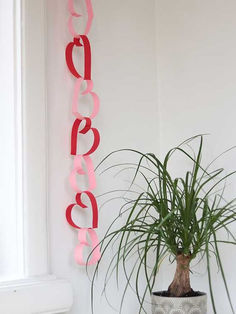 a potted plant sitting next to a sign that says love on it's side