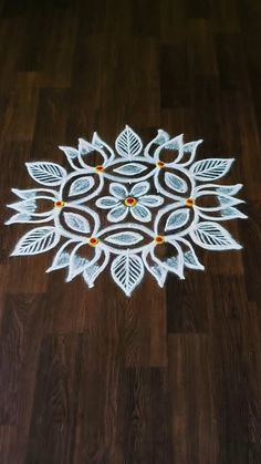 a wooden floor with a white and yellow design on it