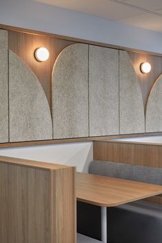 an office cubicle with wood paneling and round lights on the wall above it