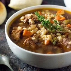 a close up of a bowl of soup on a table