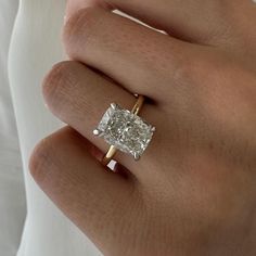 a woman's hand with a ring on it and a diamond in the middle