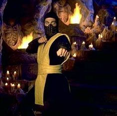 a man dressed in black and yellow with a mask on