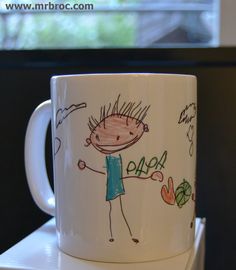 a white coffee cup with a drawing on it