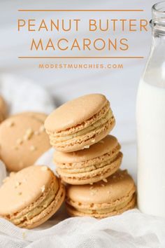 a stack of peanut butter macarons next to a bottle of milk