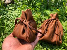 "This is a handmade leather coin pouch crafted for those who seek simplicity in their lives. It is made of soft but sturdy brown leather. With this pouch, many garments and costumes can be completed. It is perfectly suited for LARP and reenactment. These minimalistic pouches can fit perfectly in your pocket, backpack, purse, etc.  Measurements: Small Pouch = 4.5\" X 4\" X 3.5\" +/-  Large Pouch = 10\" X 7.5\" X 6.5\" +/- The high quality soft leather from Wisconsin creates the most unique coin pouch as close as it can get from the ones crafted in ancient times. Use these unique pouches to carry dried fruits, nuts, coins, jewelry, wedding rings, and more! ✅Handmade ✅100% Genuine leather ✅Dense material that will last for ages! ✅Easy to clean We take our time to make each leather coin pouch Medieval Handmade Pouch For Gift, Medieval Style Handmade Pouch For Gift, Medieval Handmade Pouch As Gift, Medieval Handmade Pouch For Everyday Use, Medieval Style Handmade Pouch For Everyday Use, Dice Pouch, Marble Bag, Crystal Pouch, Unique Pouch