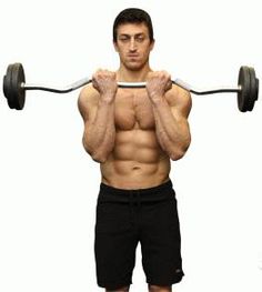 a man with no shirt is holding two barbells in front of his face