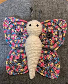 a crocheted butterfly sitting on top of a chair