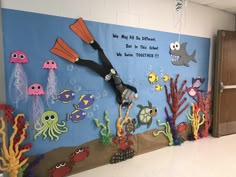 a classroom wall decorated with an ocean theme and under the sea themed bulletin board clock