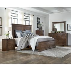 a bedroom scene with focus on the bed and dresser