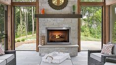 a living room with couches and a fire place inside of it on a patio