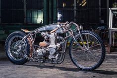 an old motorcycle is parked in a garage