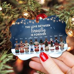 a christmas ornament hanging from a tree with the words, the love between family is forever