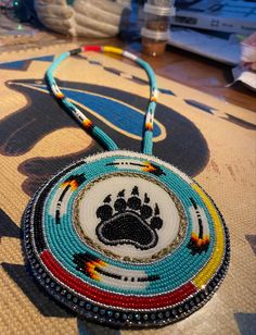 a beaded purse with a dog's paw on it