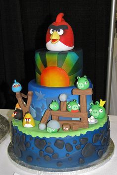 the cake is decorated with angry birds and many other characters on it's sides