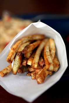 some french fries are in a paper container