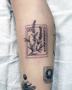 a tattoo on the arm of a woman with flowers and an old camera in it