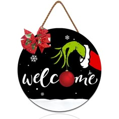 a welcome sign hanging from a rope with christmas decorations on the front and back of it