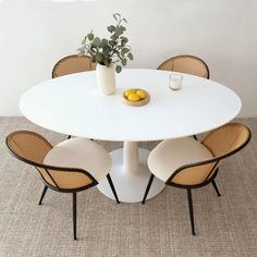 a white table with four chairs around it