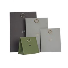 three different colored paper bags with rings on them