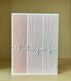 a white card with the words thinking on it and some grass in front of it