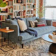 a living room filled with furniture and bookshelves