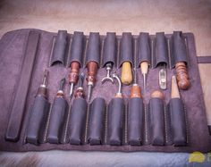 an assortment of tools in a leather case