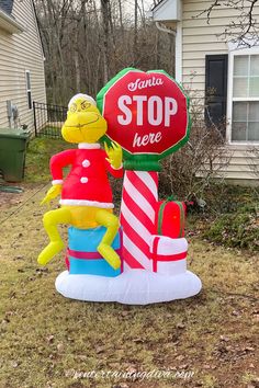 a large inflatable sign that says santa stop here