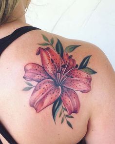 a woman with a flower tattoo on her back