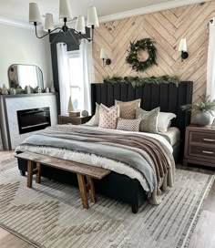 a bedroom with a bed, dresser and fireplace in the corner is decorated for christmas