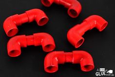 six red plastic elbow plugs on a black background with the words glue written below them