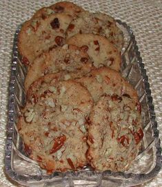 several cookies in a glass dish on a table