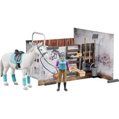 a toy horse is standing next to a dollhouse with a man and his horse