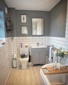 a bathroom with gray walls and white tile on the floor is shown in this image