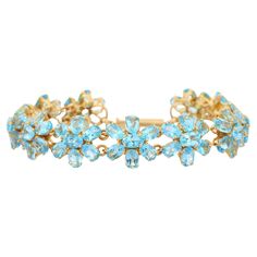 This Blue Topaz Flower Bracelet in 18K gold showcases 77 endlessly sparkling natural blue topaz, weighing 38.1 carats. It measures 7.5 inches long in length. Blue topaz helps to improve communication and self expression. Designed with perfect seven oval cut blue topaz making a flower. Eleven flowers set in repetition making a beautiful bracelet to make you stand out on any occasion or event. The elegant style complements the attire beautifully and this is a perfect Unique Gift, Bridal Shower Gif Precious Stones Bracelet, Black Diamond Bracelet, Topaz Bracelet, Bracelets Charm, Blue Topaz Bracelet, Stone Bracelets, Modern Bracelets, Gems Bracelet, Floral Bracelet