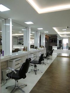 an empty salon with chairs and mirrors