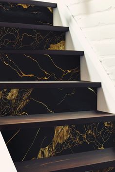 the stairs are decorated with black and gold marble