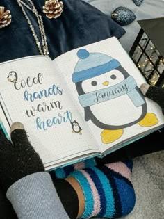 a person sitting down reading a book while wearing socks and holding a penguin on their lap