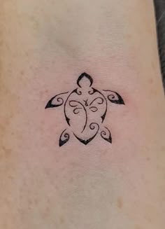 a small turtle tattoo on the ankle