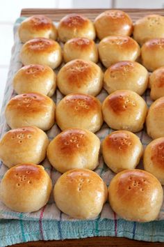 bread rolls sitting on top of a blue and white towel