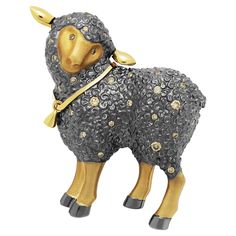 a black and gold sheep figurine on a white background